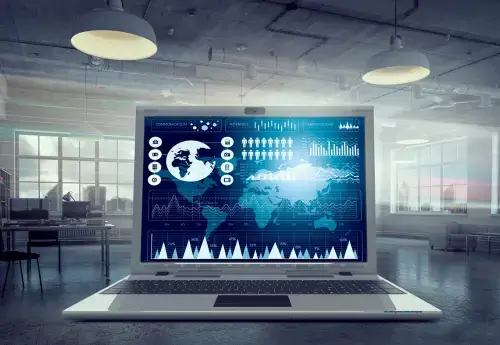 a laptop in a corporate office environment with the screen showing data about men around the world