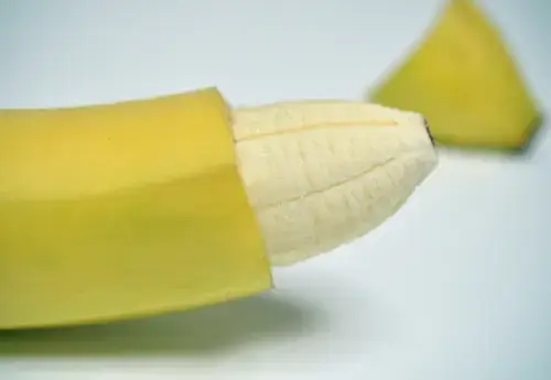 Creative representation of circumcision for adults, using a partially peeled and cut banana to symbolize the procedure. A visual metaphor illustrating the concept of adult circumcision.